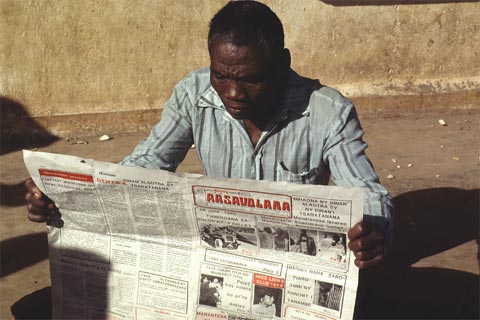 Reading a newspaper in Madagascar.