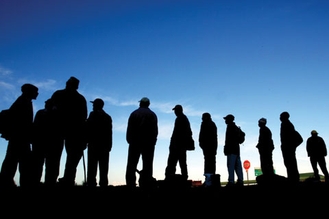 Job seekers waiting alongside a road in Cape Town, South Africa