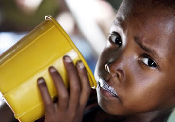 An Ethiopian child with a nutrient-rich drink provided by relief agencies