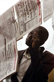 Man reading a newspaper in Kinshasa
