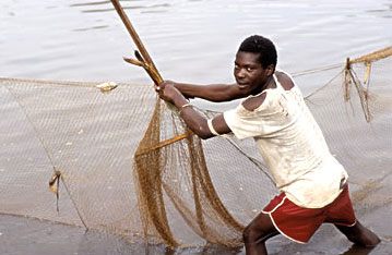 Fisherman checking a fishing a net in Uganda