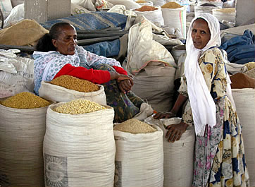 Twon women with sacks of grain