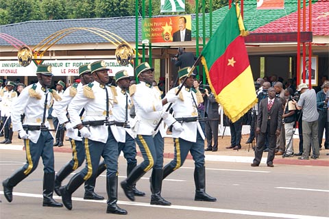 Showing the flag at the Independence Day march in Cameroon: President Paul Biya and other leaders note, however, that most African countries remain highly dependent on an international economy over which they have little influence.