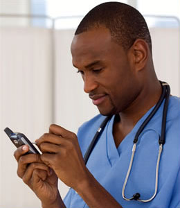 Doctor entering information into mobile phone