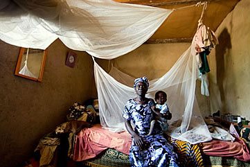 A mother and child in Ghana with insecticide-treated bed nets to protect against mosquitos carrying malaria