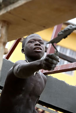 Applying cement at a construction site in Freetown, Sierra Leone