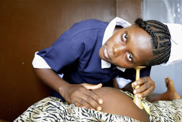 Nurse listerning to a mother’s foetus in Liberia