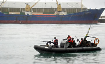 African Union forces escort a cargo ship released by Somali pirates