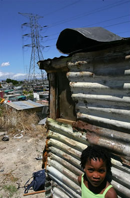 A poor neighbourhood in Cape Town, South Africa, in the shadow of a high-tension power line