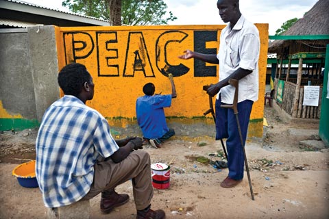 Painters decorating a wall in Juba, South Sudan
