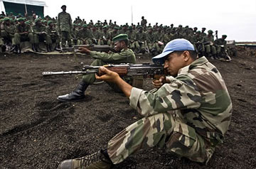 A UN peacekeeper instructs Congolese troops