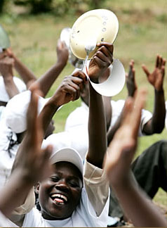 Kenyans bang spoons against plates during an October 2006