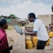 An official checks data from an internet-based water monitoring device at a borehole in Basbedo, Burkina Faso. Photo: Panos/Andrew McConnell