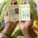A coffee farmer from Musasa, Rwanda, shows her health insurance card. Panos/Andrew Esiebo