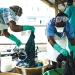 Health workers clean hospital scrubs and protective gear at the Island Clinic for Ebola treatment centre in Monrovia, Liberia, during the 2014 Ebola outbreak.   USAID/Morgana Wingard