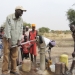 Salva Dut (left) pumps water from one of the boreholes he has helped drill in South Sudan. Photo: Water for South Sudan