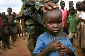 A Ugandan soldier with displaced children