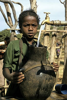 Girl at communal village water tap in Ethiopia