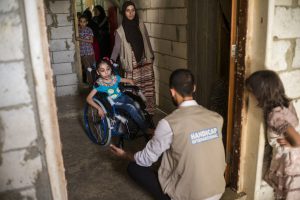 A Syrian child in a wheelchair during a phyisotherapy session.