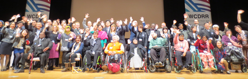 Image of members of the Disability-Inclusive Disaster Risk Reduction Caucus on the stage at the DESA DSPD Forum