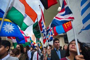 Students carrying Members States’ flags during the annual Peace Bell Ceremony held in observance of the 2015 International Day of Peace.