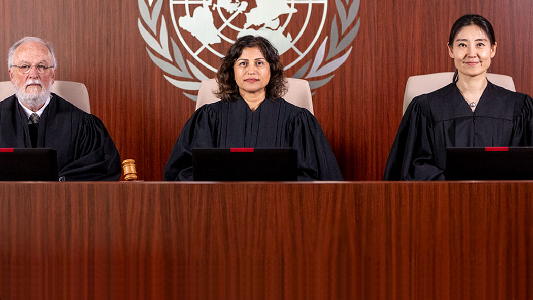 Photo of UN Appeals Tribunal judges reading pronouncement of decisions in Amman, Jordan