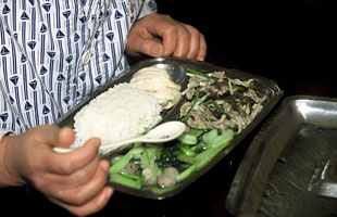 A person eating a healthy dish with vegetables.
