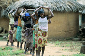 photo of women and girls carrying water