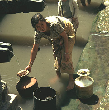 A young woman collecting water
