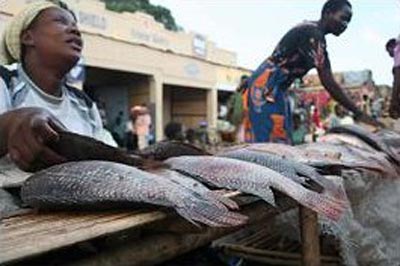 Gender equality and sustainable urbanization: Female fish vendor © Caylee Hong/ UN-HABITAT