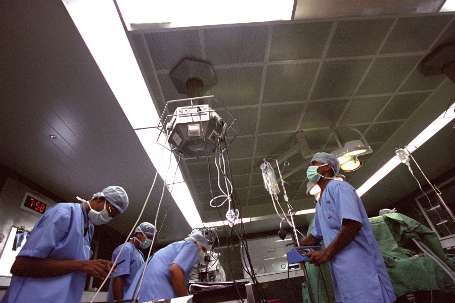  Surgeons in the operating theatre at a Bangalore hospital, Bangalore , India. Photo credit: Panos/B. Lawley