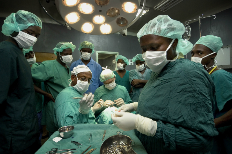 Medical students watch as doctors perform an operation in Moshi, Tanzania. Photo credit: Panos/ Sven Torfinn