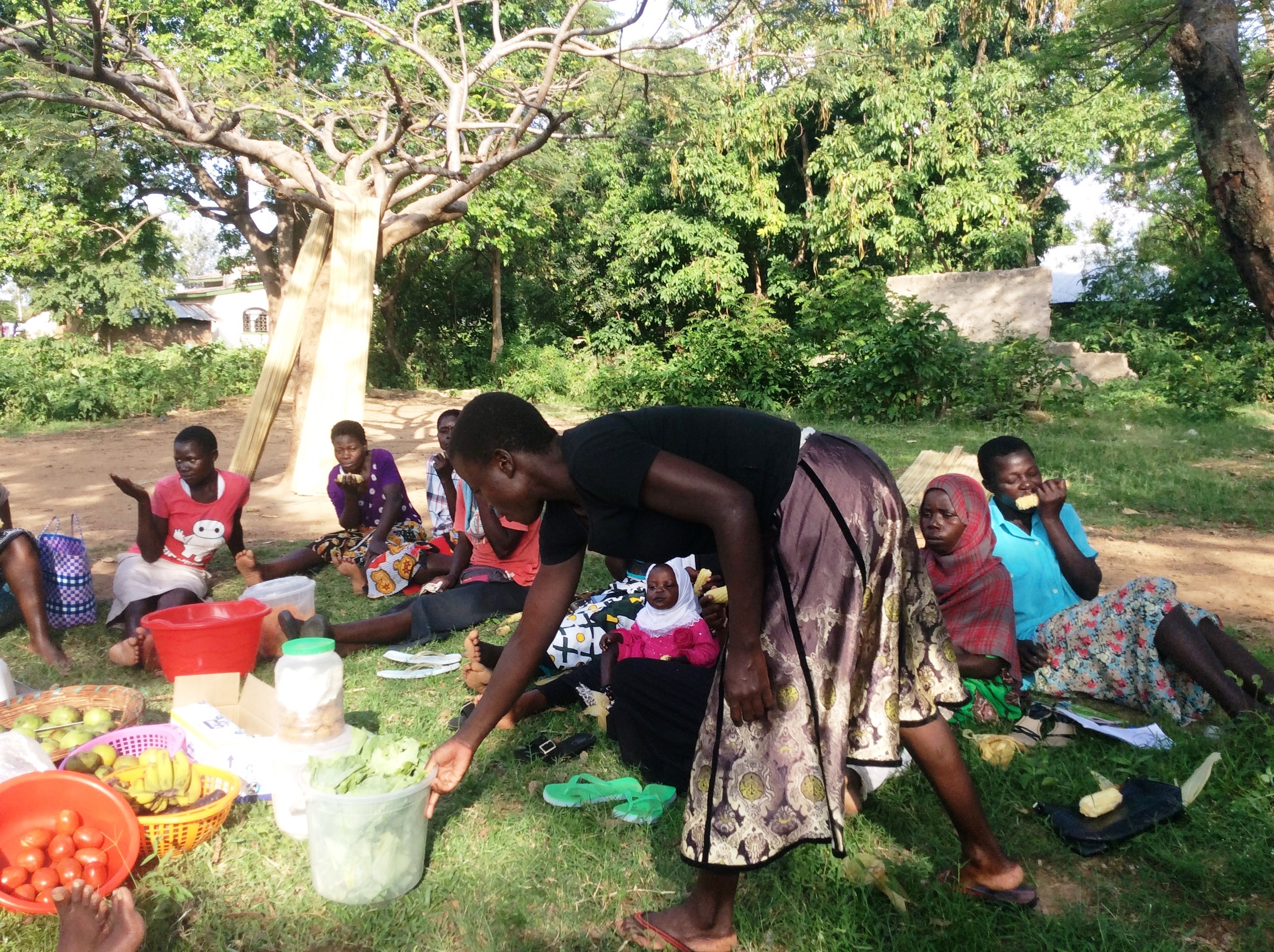 Eunice Achieng Omondi, a survivor of violence hands checks on the vegetables she is taking to the market during a meeting with members of Usoma Support Group for Survivors of Violence in Kisumu. Picture Jane Godia