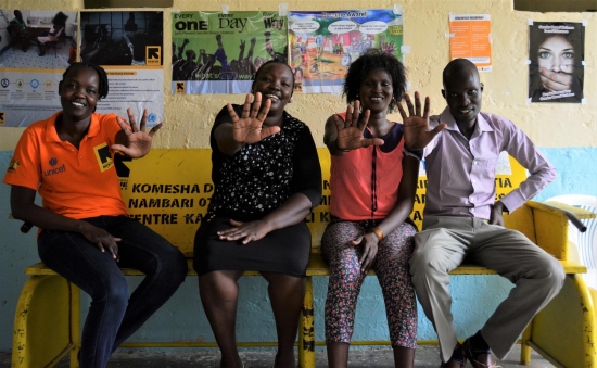 Staff at the Lodwar Hospital Wellness Centre make a 'stop violence against children' hand sign in February 2020 (before the outbreak of COVID-19 in Kenya). The centre supports child survivors of violence and abuse.