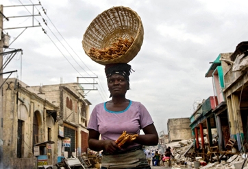 A woman walking through the rubble in downtown Port au Prince