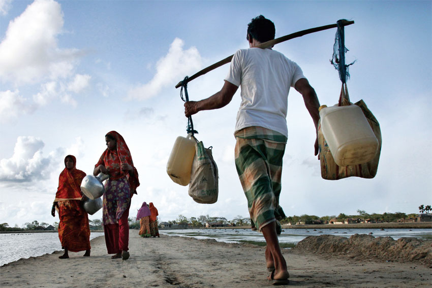 Above, people carry drinking water in Bangladesh