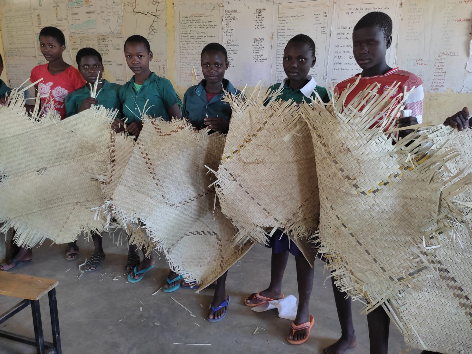 Some of the girls who board in the school display their beddings.