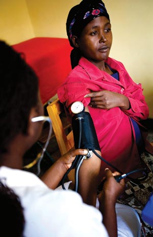 Checking the blood pressure of an expectant mother in Rwanda.