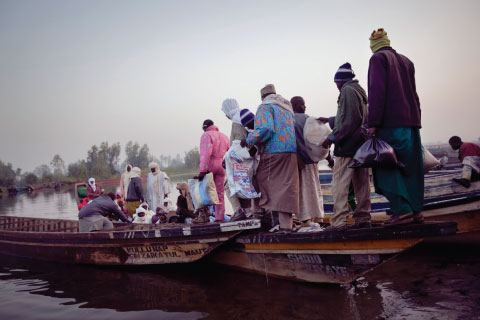 Passengers in Nigeria taking ferries to cross Lake Chad, whose shoreline is receding because the lake is drying up