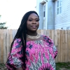 Lourena Gboeah in front of her home