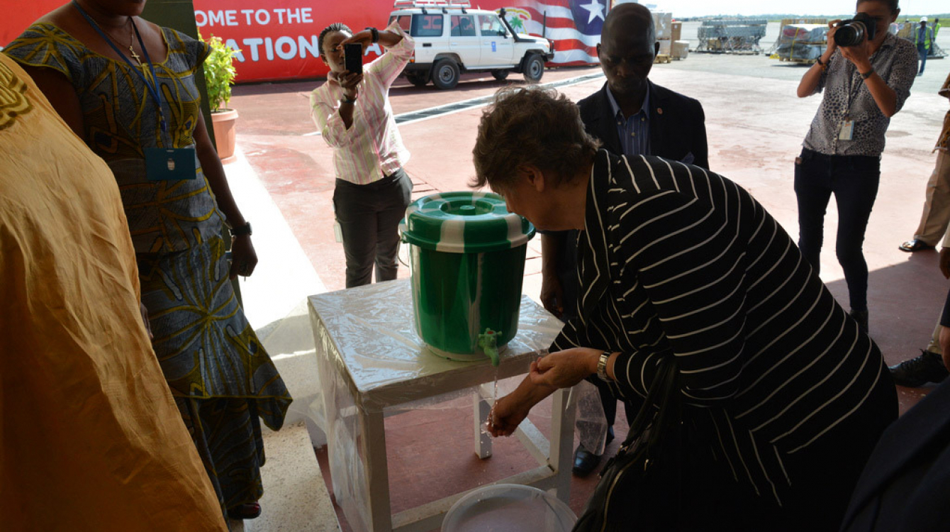 UN Development Program (UNDP) Administrator Helen Clark washes her hands on arrival in Ebola-affected Monrovia, Liberia. Photo: UNDP/Dylan Lowthian