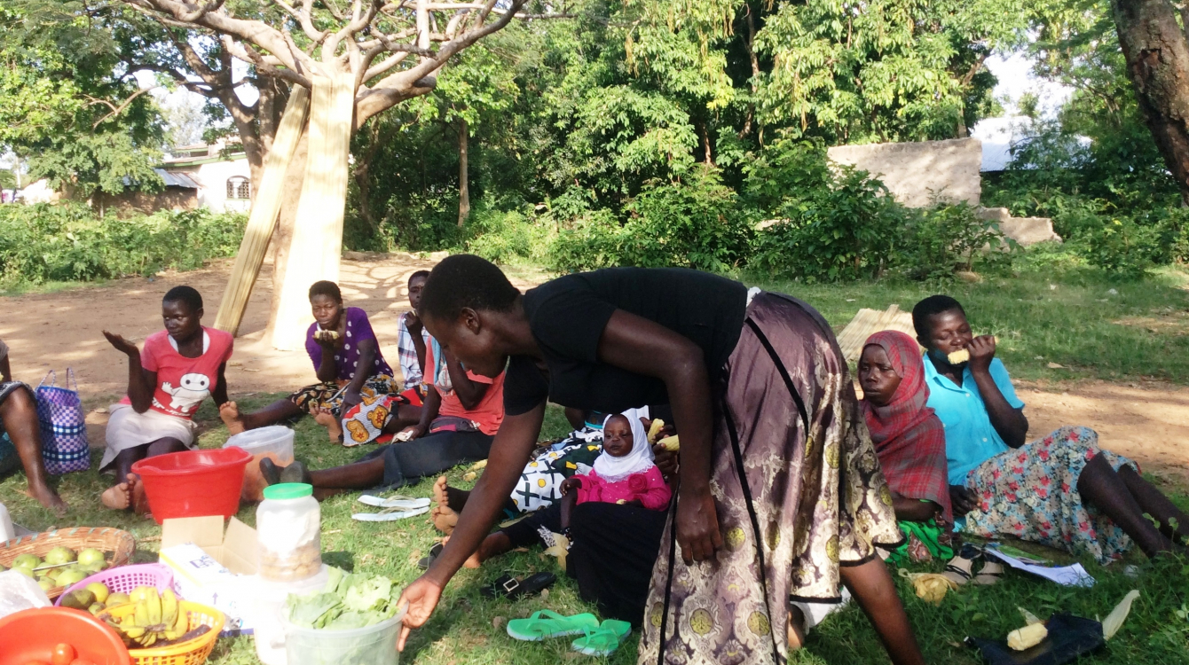 Eunice Achieng Omondi, a survivor of violence hands checks on the vegetables she is taking to the market during a meeting with members of Usoma Support Group for Survivors of Violence in Kisumu. Picture Jane Godia