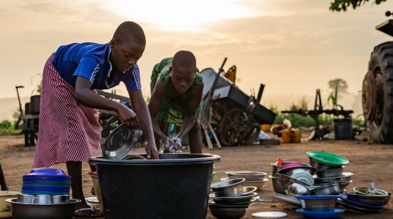 Girls washing dishes in Lome, Togo.