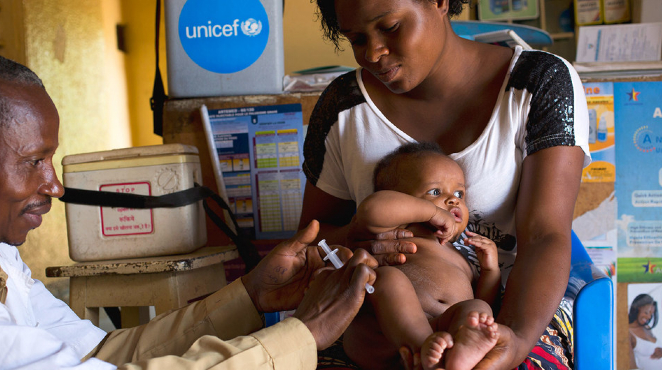 A mother holds her 3-month-old baby as he receives a vaccination against measles at a health centre in Lubumbashi, Democratic Republic of the Congo.