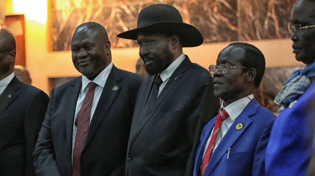 Salva Kiir, President of South Sudan, (centre right) shakes hands with Riek Machar, who was sworn in as First Vice President of the new Transitional Government of National Unity on 22 February 2020.