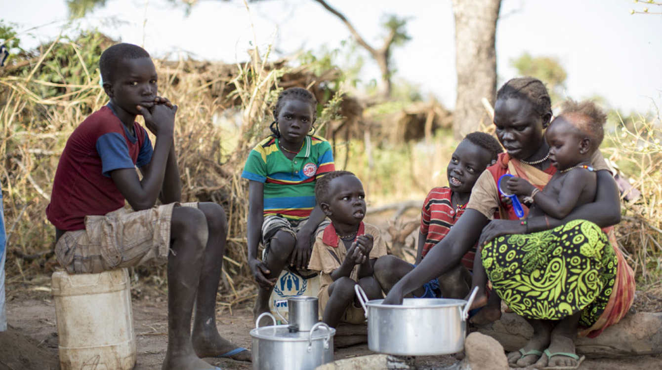 Sudanese refugee Amal Bakith cooks the first breakfast for her children a day after arriving in Ajuong Thok camp, South Sudan. During their long journey from South Kordofan, they had only rotten food to eat. Photo: UNHCR/Rocco Nuri