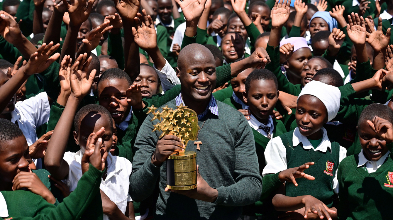 Teacher and Franciscan brother Peter Mokaya Tabichi, 36, holds his Global Teacher Award as he is cheered on by his students at Keriko Secondary School in Njoro, Nakuru county.            Getty Images/ Tony Karumba