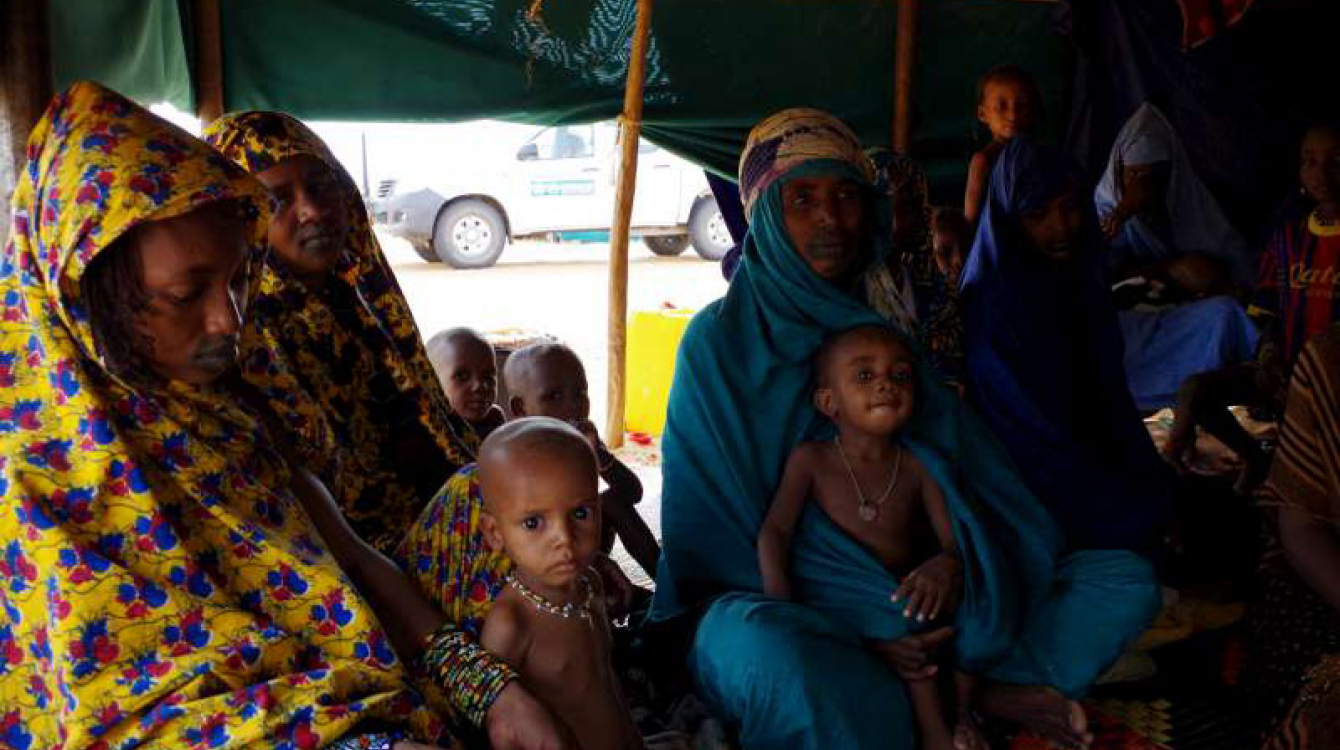 New arrivals from Mali sit inside one of the tents at Mbera Camp, some 50 kilometres inside Mauritania