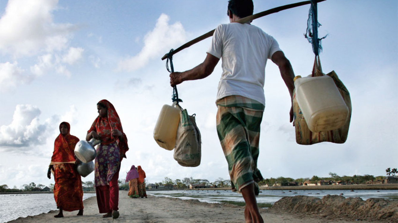 Above, people carry drinking water in Bangladesh