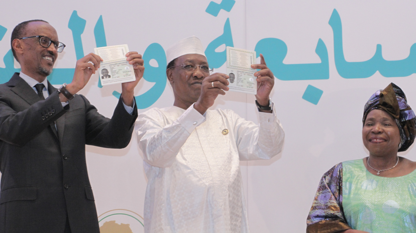 Rwandan President Paul Kagame and Chadian President Idriss Déby, flanked by African Union Commission Chairperson Nkosazana Dlamini-Zuma, show off their new pan-African passports at the AU summit in Kigali in July 2016. Photo: African Union